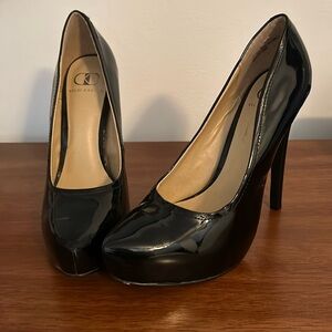 Kelsi Dagger black patent pumps